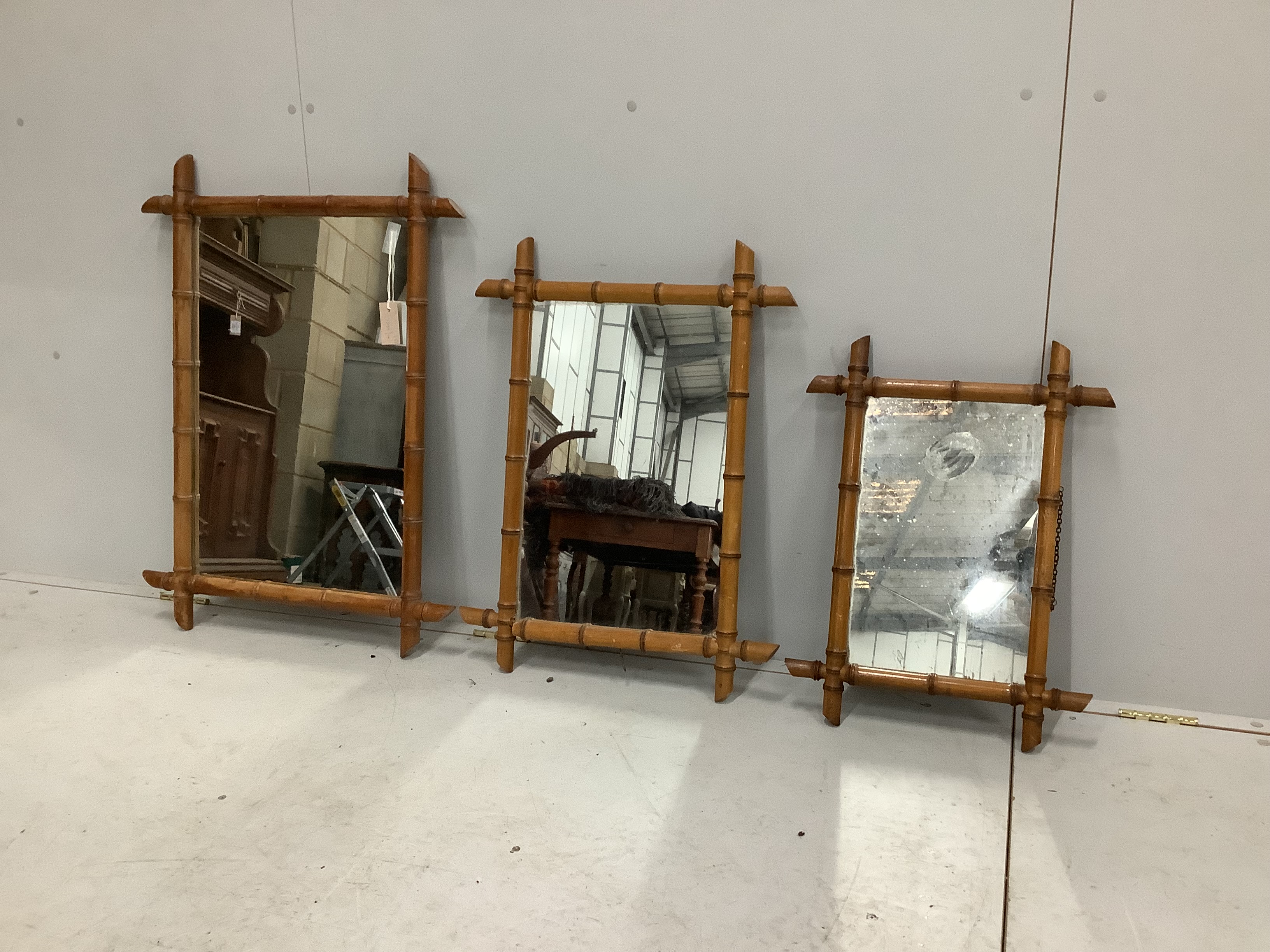 A graduated set of three French rectangular faux bamboo wall mirrors, largest width 63cm, height 83cm